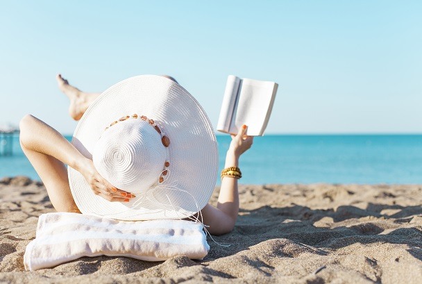 woman reading on beach